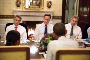 El primer ministro británico, David Cameron, flanqueado por funcionarios del Reino Unido, asiste a la cena en la Casa Blanca en enero de 2015. (Pete Souza / Casa Blanca)